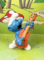 The Smurfs - Schleich - 20023 Bass guitar Smurf (orange bass & ochre cords)