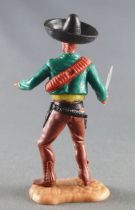 Timpo - Mexicains - Piéton pose du couteau veste verte sombrero noir jambes marrons pied droit devant